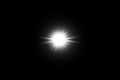 Digital lens flare, sun burst on black background.