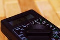 Digital measuring multimeter on wooden floor. It shows 4.33V or fully charged battery. Includes voltmeter, ampermeter, ohmmeter Royalty Free Stock Photo