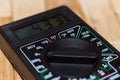 Digital measuring multimeter on wooden floor. It shows 4.33V or fully charged battery. Includes voltmeter, ampermeter, ohmmeter Royalty Free Stock Photo