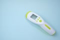 medical infrared forehead thermometer gun non contact for measuring temperature, for COVID testing on blue background. Royalty Free Stock Photo