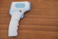 Digital medical infrared non contact thermometer gun for measuring temperature on wooden background for coronavirus Royalty Free Stock Photo