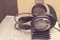 Digital midi keyboard, headphones and acoustic guitar. Royalty Free Stock Photo