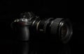 Digital mirrorless camera isolated on dark black banner