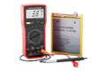 Digital multimeter and Lithium Ion Cell Phone Battery, 3D rendering Royalty Free Stock Photo