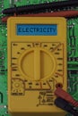 Digital multimeter multitester on a circuit board with the word electricity Royalty Free Stock Photo