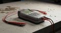 Digital Multimeter with Probes on Concrete Surface Royalty Free Stock Photo