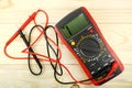 Digital multimeter with probes on a wooden table Royalty Free Stock Photo