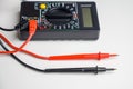 Digital multimeter with test leads on a white table. A multimeter is an electronic measuring instrument Royalty Free Stock Photo