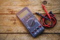 Digital multimeter and wiring on wooden table. special tools of technician for work with circuit and electrical.