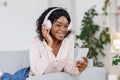 Digital Music Service. Smiling Black Girl In Headphones, Listening Songs On Smartphone Royalty Free Stock Photo