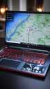 Digital navigation, laptop showing 3D map pointer indicating a specific location