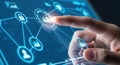 Digital network connection showing interconnected futuristic icons with a human finger activating a glowing node on a blue screen Royalty Free Stock Photo