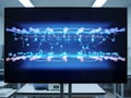 Digital network visualization displayed on a large monitor in a lab setting Royalty Free Stock Photo