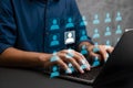 Digital Networking Interface with Highlighted User Icon and Laptop Typing Royalty Free Stock Photo