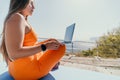 Woman laptop sea. Working remotely on seashore. Happy successful woman female freelancer working on laptop by the sea at Royalty Free Stock Photo