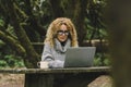 Digital nomad traveler people concept work lifestyle. Alternative outside office in the nature. Pretty woman in smart working on Royalty Free Stock Photo