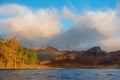 Digital painting of Blea Tarn in the English Lake District with views of the Langdale Pikes, and Side Pike during autumn Royalty Free Stock Photo