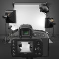 Digital photo camera in studio with softbox and flashes. Royalty Free Stock Photo