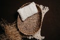 Digital photography newborn background - brown backdrop with rattan woven basket, biege macrame rag and white knitted pillow