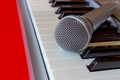 Digital piano keyboard with microphone on red bacground Royalty Free Stock Photo