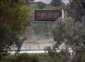 Digital road sign stating Severe Weather Use Caution on the 15 freeway Royalty Free Stock Photo