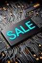 Digital sale chip on a black circuit board Royalty Free Stock Photo