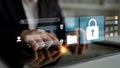 Digital security concept with hands using tablet and holographic interface featuring lock icon and data icons in modern Royalty Free Stock Photo