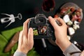 Digital single-lens reflex camera in hands. Man photographer makes photos. Male hands hold the camera close-up Royalty Free Stock Photo