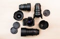 Digital SLR camera and a few interchangeable manual lenses. The equipment for filmmaking. The wooden table Royalty Free Stock Photo