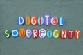 Digital sovereignty, creative logo composed with multi colored stone letters over green sand