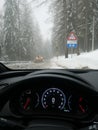 Digital speedometer - driving in snÃÂ³w condition thru a forest in mountains