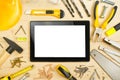 Digital Tablet and Assorted Carpentry Tools on Workshop Table