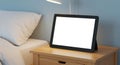 Digital Tablet with Blank Screen on Bedside Table Mockup Royalty Free Stock Photo