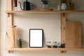 Digital tablet with blank screen on kitchen shelf surrounded by glass jars, pasta, and spices Royalty Free Stock Photo