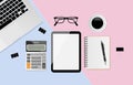 Digital tablet with blank screen and notebook, pen, black metallic paper clips, calculator, coffee cup, eyeglasses and laptop on Royalty Free Stock Photo