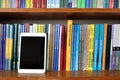 Digital tablet on the books shelves