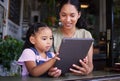 Digital tablet, coffee shop and mother with her child reading the online menu before ordering. Technology, internet and Royalty Free Stock Photo