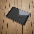 Digital Tablet Computer with Blank Screen on Rustic Wooden Table Top Royalty Free Stock Photo