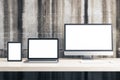 Digital tablet, computer monitor and laptop with blank screen on table o