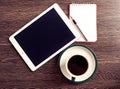 Digital tablet computer with note paper and cup of coffee Royalty Free Stock Photo