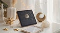 Digital tablet displaying celestial chart on white books with gold decor items and crystals Royalty Free Stock Photo