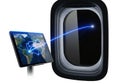 Digital tablet displaying globe with flight path near airplane window at night Royalty Free Stock Photo