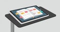 A digital tablet displaying an open notebook interface rests on a black, rectangular Royalty Free Stock Photo