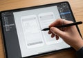 A digital tablet displaying a user interface design app with wireframes for a mobile application. A Royalty Free Stock Photo
