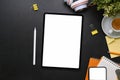 Tablet with empty screen, mobile phone, stylus pen and office supplies on black leather. Royalty Free Stock Photo