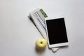 Digital tablet, folded newspaper and apple Royalty Free Stock Photo
