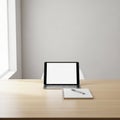 Digital tablet on a keyboard stand and a blank screen positioned in front Royalty Free Stock Photo