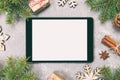 Digital tablet mock up with rustic Christmas gray cement background decorations for app presentation. top view with copy space. Royalty Free Stock Photo