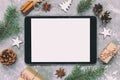 Digital tablet mock up with rustic Christmas gray cement background decorations for app presentation. top view with copy space.