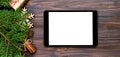 Digital tablet mock up with rustic Christmas wood background decorations for app presentation. top view banner with copy space Royalty Free Stock Photo